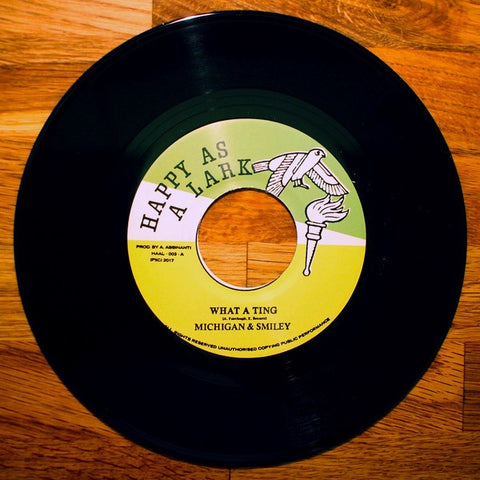 Michigan & Smiley / Ray Jacildo ‎– What A Ting / Murder At Strange Manor - New 7" Vinyl - 2017 Happy As A Lark (Chicago, IL) Stereo Pressing with Promo Card and Sticker - Reggae / Dancehall