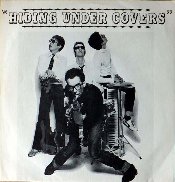 Elvis Costello – Hiding Under Covers - Mint- 7" Single Record 1982 Mr Norman Brain  UK Vinyl - New Wave / Punk - Shuga Records